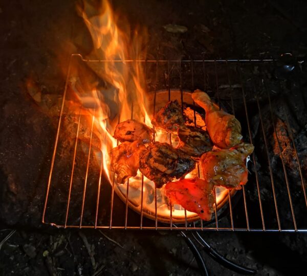 Campers making BBQ at Yahangala campsite surrounded by mountains.