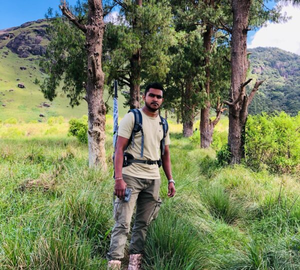 Trekker standing near Haritha Kanda Mountain hiking trail